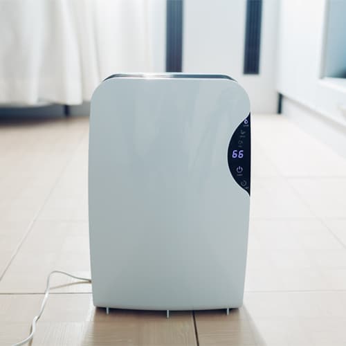 A dehumidifier is a device that draws moisture out of the air. A fan in the dehumidifier pulls air from the surrounding area into the unit. A dehumidifier is a device that draws moisture out of the air. A fan in the dehumidifier pulls air from the surrounding area into the unit.